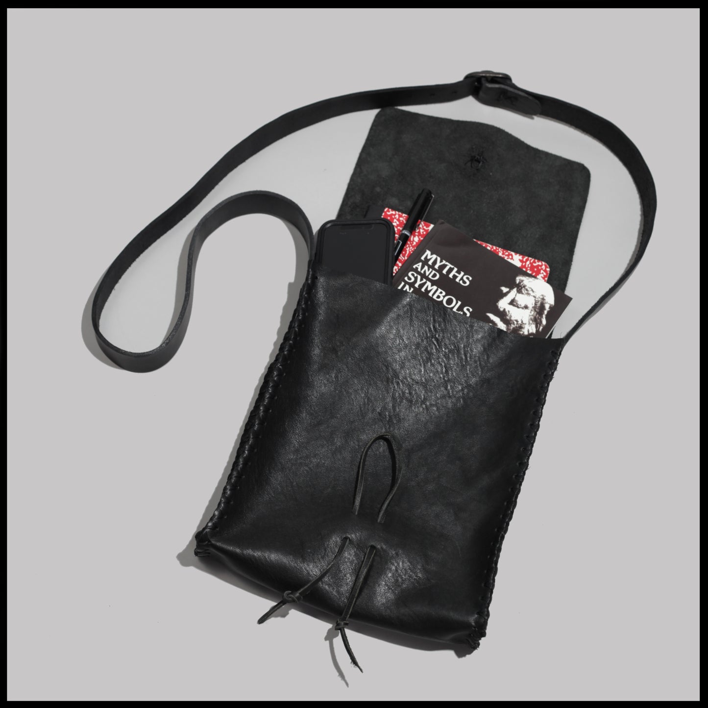 Black hand-stitched leather shoulder bag w/ hand-carved Deer antler Sun Wheel closure