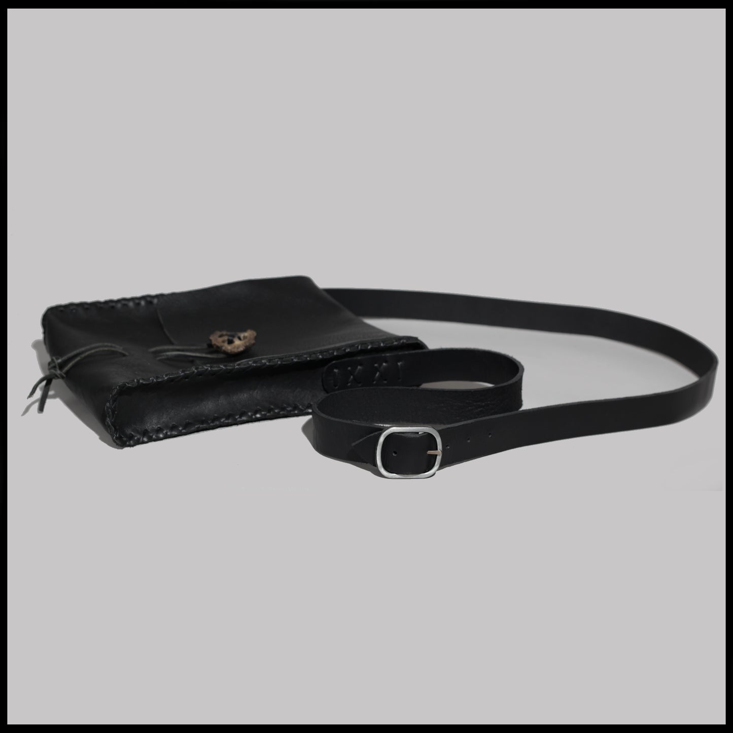 Black hand-stitched leather shoulder bag w/ hand-carved Deer antler Sun Wheel closure
