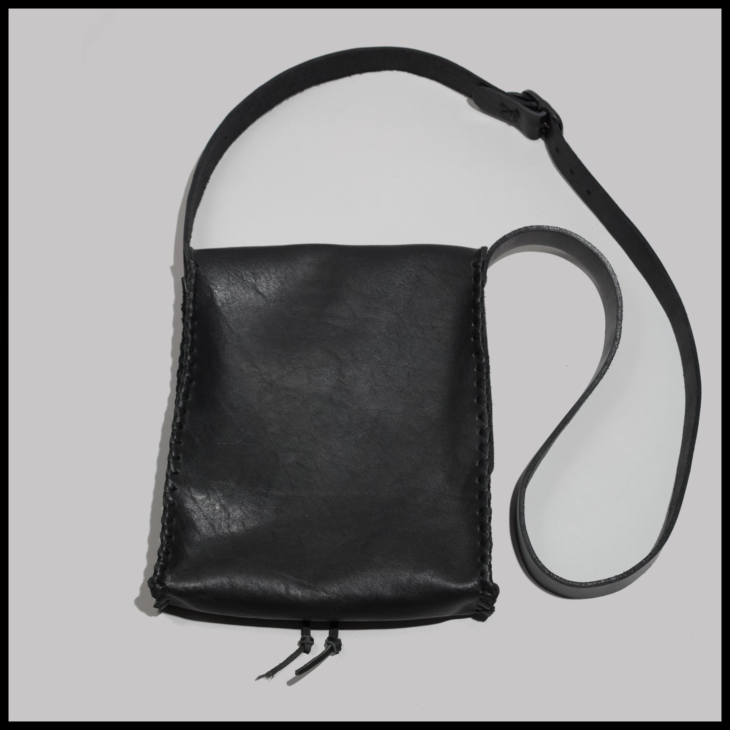 Black hand-stitched leather shoulder bag w/ hand-carved Deer antler Sun Wheel closure