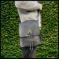 Black hand-stitched leather shoulder bag w/ hand-carved Deer antler Sun Wheel closure